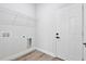 A laundry room with hookups, wire rack shelving and white door at 166 Marion Oaks Ln, Ocala, FL 34473