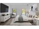 A well-lit bedroom with hardwood floors, two large windows, and modern decor at 166 Marion Oaks Ln, Ocala, FL 34473