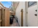 Side yard featuring a wooden fence, gate, and exterior door at 1701 Clouser Ave, Orlando, FL 32804