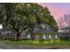 Charming two-story home with a well-maintained lawn and mature tree at dusk at 1701 Clouser Ave, Orlando, FL 32804