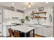 Bright kitchen featuring white cabinetry, an island with seating, and stainless steel appliances at 1701 Clouser Ave, Orlando, FL 32804