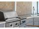 Outdoor kitchen featuring a stainless steel grill, countertop space, and tiled backsplash at 1701 Clouser Ave, Orlando, FL 32804