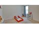 bedroom with playful decor, carpeted floors, and a window with blue curtains at 1750 Eagle Hammock Blvd, Eagle Lake, FL 33839