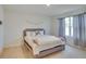 Cozy bedroom featuring a queen-sized bed with a padded headboard and soft, neutral-toned carpet at 1750 Eagle Hammock Blvd, Eagle Lake, FL 33839