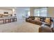 Open concept living space with a leather sofa, stools at the breakfast bar, and an adjacent dining area at 1750 Eagle Hammock Blvd, Eagle Lake, FL 33839