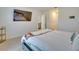 Main bedroom showing bed, wall-mounted TV, and view into the en-suite bathroom at 1750 Eagle Hammock Blvd, Eagle Lake, FL 33839