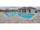 Community pool with blue tiling, surrounding lounge chairs, and a nearby playground at 1750 Eagle Hammock Blvd, Eagle Lake, FL 33839