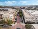 Aerial view of a bustling town center with shops, apartments, and a brick-paved street at 1859 Britlyn Aly, Orlando, FL 32814