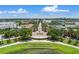 Community with central park featuring a decorative fountain and grassy amphitheater surrounded by stores and restaurants at 1859 Britlyn Aly, Orlando, FL 32814