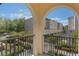 Balcony view of community buildings, lush landscaping, and blue sky at 1859 Britlyn Aly, Orlando, FL 32814