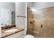 Bathroom with beautiful vanity, stone countertop, walk-in shower with glass door, and neutral tile at 1859 Britlyn Aly, Orlando, FL 32814