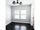 A well-lit room features dark wood floors, two windows, and a modern ceiling fan at 1859 Britlyn Aly, Orlando, FL 32814