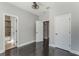 The bedroom boasts dark wood floors and multiple doorways for easy access at 1859 Britlyn Aly, Orlando, FL 32814
