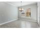 Light-filled dining room with tile floors, large windows, chandelier, and modern finishes at 1859 Britlyn Aly, Orlando, FL 32814