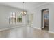 Bright dining area with tile floors, chandelier, and french doors to the backyard at 1859 Britlyn Aly, Orlando, FL 32814