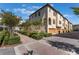 Beautiful townhome with tan stucco, arched balcony and attached one car garage at 1859 Britlyn Aly, Orlando, FL 32814