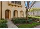 Inviting home exterior features arched entryway, well-maintained landscaping, and a pathway leading to the front door at 1859 Britlyn Aly, Orlando, FL 32814
