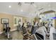 Community gym featuring a variety of fitness equipment, ceiling fans, and natural light from large windows at 1859 Britlyn Aly, Orlando, FL 32814