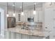 Contemporary kitchen equipped with stainless appliances, granite counters and white cabinetry at 1859 Britlyn Aly, Orlando, FL 32814