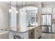 Modern kitchen island boasts sleek countertops, stainless steel appliances, and contemporary pendant lights at 1859 Britlyn Aly, Orlando, FL 32814