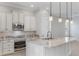 Well-equipped kitchen featuring granite countertops, stainless steel appliances, and ample cabinet space at 1859 Britlyn Aly, Orlando, FL 32814
