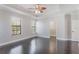 Spacious main bedroom featuring dark wood floors, tray ceiling, and plenty of natural light at 1859 Britlyn Aly, Orlando, FL 32814