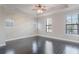 Bright main bedroom with hardwood floors, three windows, and neutral paint at 1859 Britlyn Aly, Orlando, FL 32814