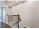 A well-lit staircase features dark wood floors and a wrought iron railing, adding a touch of elegance at 1859 Britlyn Aly, Orlando, FL 32814