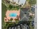 Aerial view of a pool, clubhouse, and parking spaces at 1948 Lake Atriums Cir # 129, Orlando, FL 32839