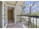 View from the balcony with railing and view of a tree and nearby street at 1948 Lake Atriums Cir # 129, Orlando, FL 32839