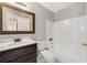 Updated bathroom with a dark wood vanity, white countertop and white tiled tub surround at 1948 Lake Atriums Cir # 129, Orlando, FL 32839