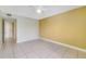 A bright bedroom features tile flooring and a ceiling fan at 1948 Lake Atriums Cir # 129, Orlando, FL 32839