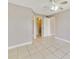 Spacious bedroom with neutral walls, tile flooring, and ample closet space at 1948 Lake Atriums Cir # 129, Orlando, FL 32839