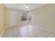 A sunlit bedroom with a ceiling fan, tile flooring, and natural light at 1948 Lake Atriums Cir # 129, Orlando, FL 32839
