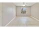 Neutral bedroom with large window and tiled floor, offering space and natural light at 1948 Lake Atriums Cir # 129, Orlando, FL 32839