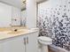 Functional bathroom featuring a vanity, a toilet, and a shower with a patterned curtain at 2413 Tack Room Ln # 2, Orlando, FL 32812