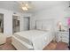 Comfortable bedroom with carpet, a white bed frame, and a glimpse into the en-suite bathroom at 2413 Tack Room Ln # 2, Orlando, FL 32812