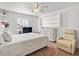 Cozy bedroom showcasing a bed, a dresser, a window, and a comfortable recliner chair at 2413 Tack Room Ln # 2, Orlando, FL 32812