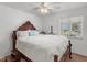 A comfy bedroom with a wooden bed frame, neutral walls, and a window that offers natural light at 2413 Tack Room Ln # 2, Orlando, FL 32812