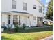 Charming two-story exterior with a well-maintained lawn, an inviting front door, and a bay window at 2413 Tack Room Ln # 2, Orlando, FL 32812