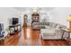 Bright living room with hardwood floors, a ceiling fan, and a comfortable sectional sofa at 2413 Tack Room Ln # 2, Orlando, FL 32812