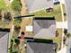 Aerial view of a home showcasing a spacious backyard, a white fence, and a red shed at 2491 Bracknell Forest Trl, Tavares, FL 32778