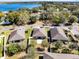 This aerial view shows the lovely homes with spacious yards with a scenic lake in the background at 2491 Bracknell Forest Trl, Tavares, FL 32778