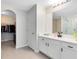 Bathroom featuring double vanity with modern fixtures, a walk-in shower, and walk-in closet at 2491 Bracknell Forest Trl, Tavares, FL 32778