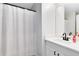Bathroom featuring a single sink vanity with white countertops and shower with white curtain at 2491 Bracknell Forest Trl, Tavares, FL 32778