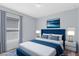 Bedroom featuring a bright window, bedside lamps, and a mounted television at 2491 Bracknell Forest Trl, Tavares, FL 32778