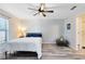 Bedroom featuring a ceiling fan, wood-look floors, and an ensuite bathroom at 2491 Bracknell Forest Trl, Tavares, FL 32778