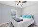 Bedroom featuring wood-look floors, a ceiling fan and bright window at 2491 Bracknell Forest Trl, Tavares, FL 32778
