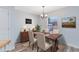 Cozy dining room with wood floors, decorative rug and natural light from a window at 2491 Bracknell Forest Trl, Tavares, FL 32778