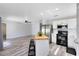 Open-concept layout with stainless steel appliances, a kitchen island, and lots of light at 2491 Bracknell Forest Trl, Tavares, FL 32778
